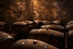 Oak barrels in the Bodega Furlotti cellar, with a shaft of light falling on the wall of an old concrete wine vat